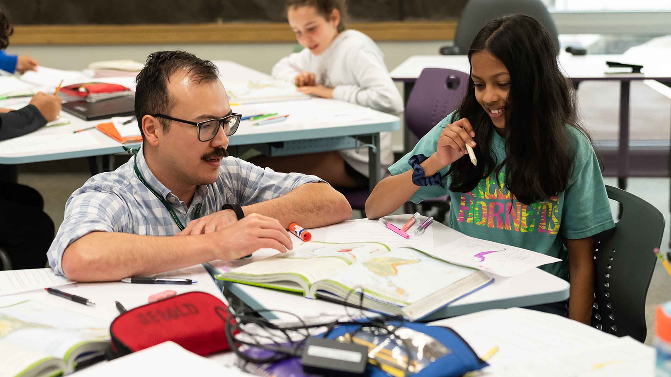 Teacher working with students